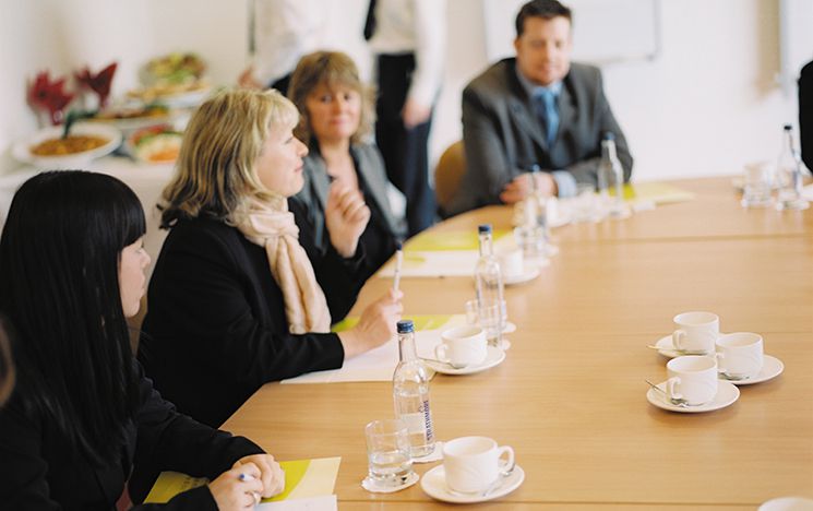 People round a meeting table