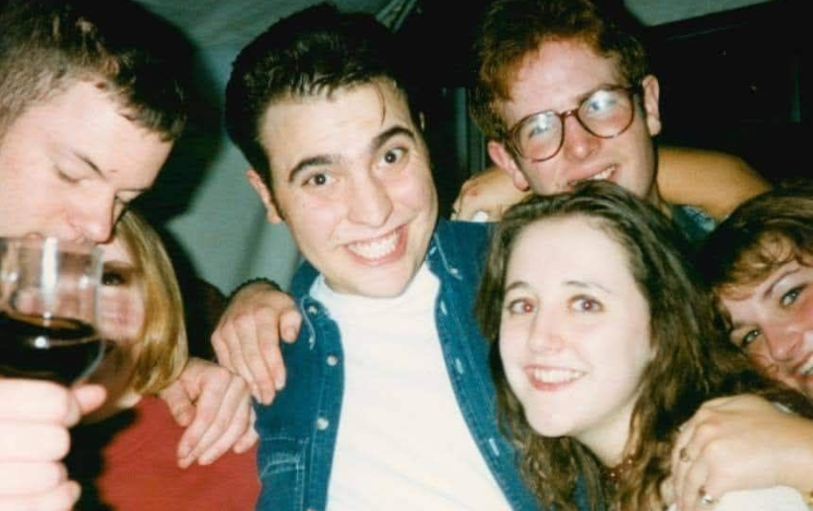 An image of Joanne and Gareth in the 1990s at Sussex, surrounded by friends.