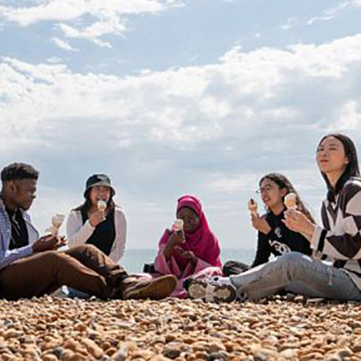 Students eating ice cream on Brighton beach