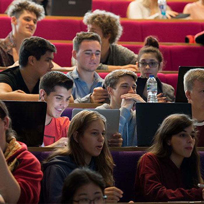 Students sitting in a lecture theatre.