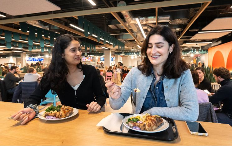 Two students enjoy a meal at Eat Central