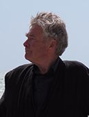 A photo of Professor Julian Perry Robinson with background of sea and sky
