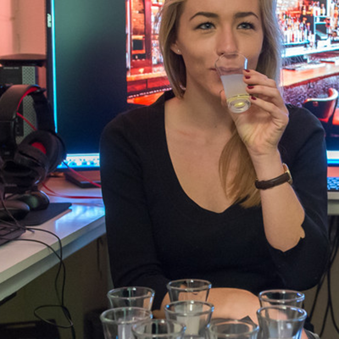 A person drinking an alcoholic drink.