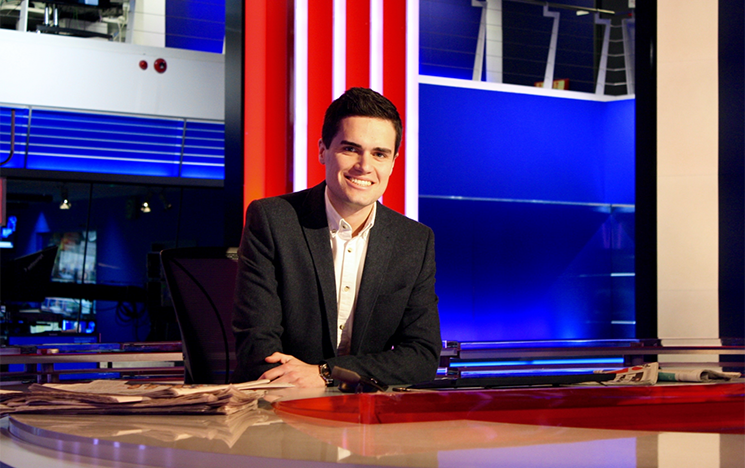 Kit Bradshaw in a news studio