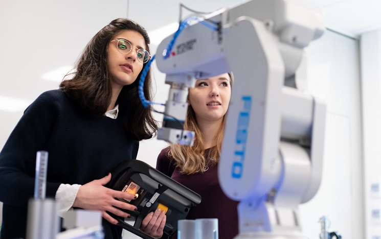 Two students looking at a piece of scientific equipment