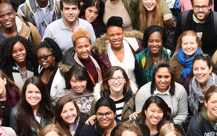 A crowd of postgraduate students smiling