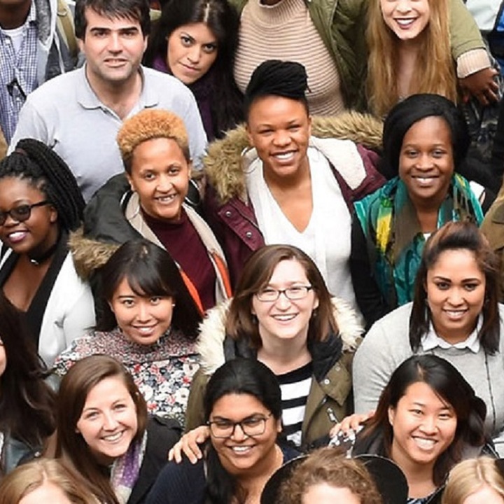 A crowd of postgraduate students smiling