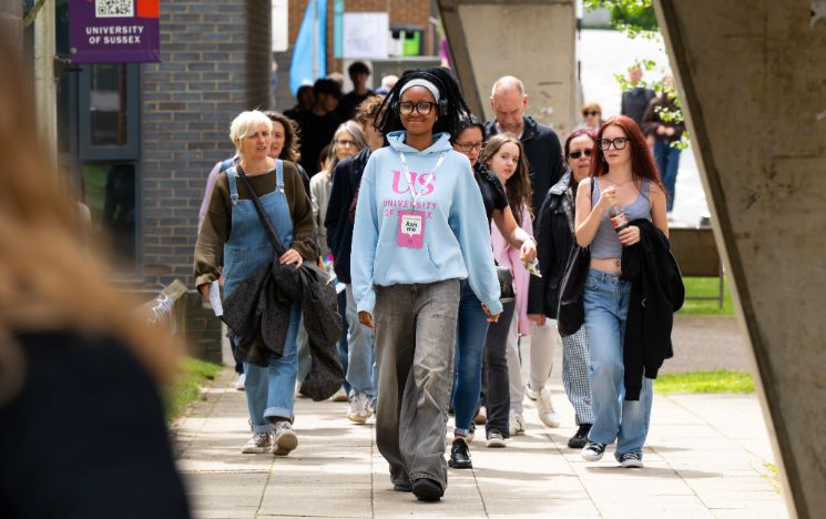 A Student Ambassador leads a tour of campus on an Open Day