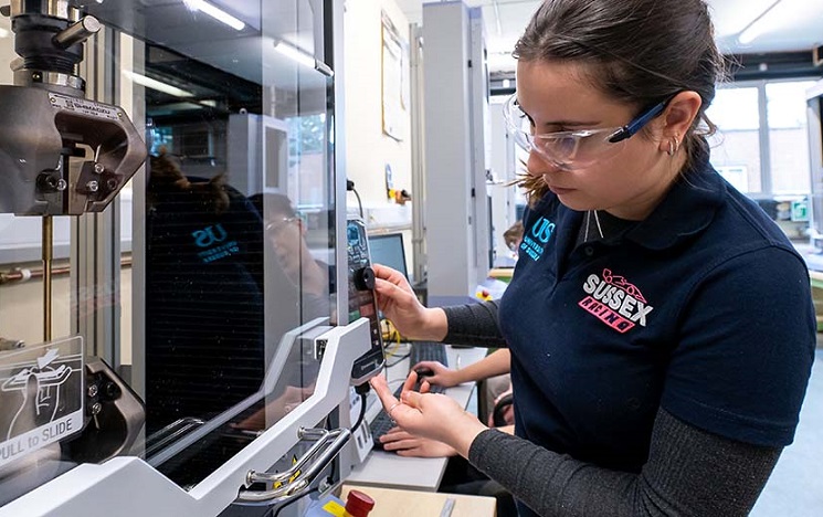 A student working at machinery in a lab