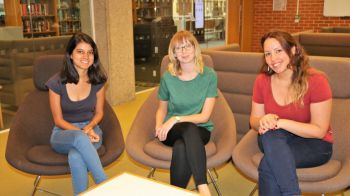 Three female Research Hive Scholars sitting down in a row