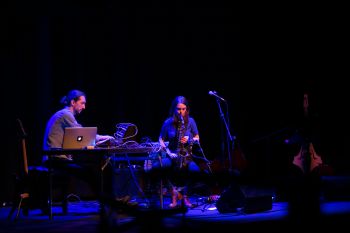 Danny Bright (on synthesize) and Mimi Haddon (on saxophone) perform onstage at the Attenborough Centre
