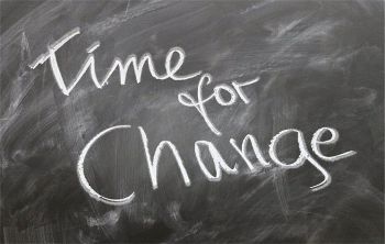 'Time for change' written in chalk on a blackboard