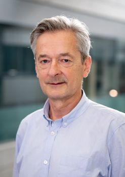 Head and shoulders image of Prof Michael Gasiorek wearing a light shirt