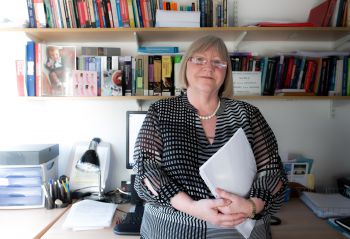 Portrait photograph of Professor Heather Keating in her office.