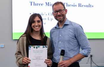 3MT winner Belinda Zakrzewska is awarded a certificate by Jeremy Niven.