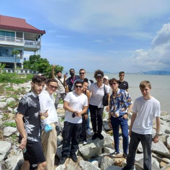 Group of Business School students and faculty at the beach in Malaysia