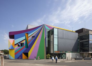 Photograph of exterior of Towner Eastbourne Gallery with some people approaching and blue sky behind