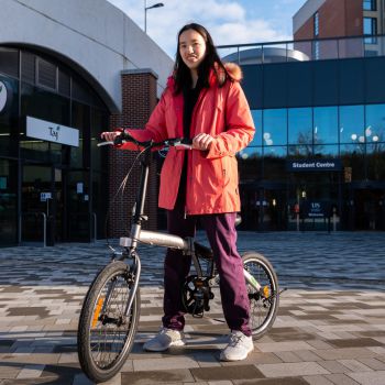 An image of the bike winner, stood with their bike.