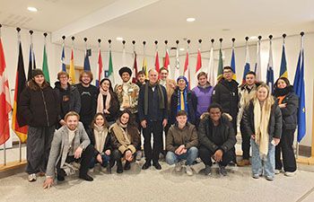 Economics students posing in a group shot in Brussels