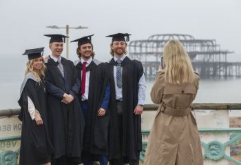 Students capturing moment from Winter Graduation along Brighton seafront