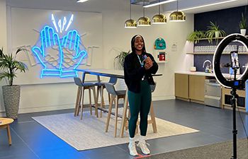 Jamila Campbell-Allen at her LinkedIn office creating content with a ring light