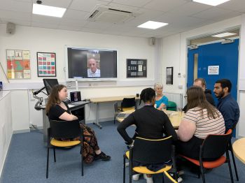 Students sharing details of their research projects with Dr Davis and Margaret Kroto