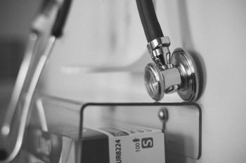 A black and white image of a stethoscope close up on a box