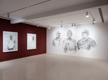 Corner angle view showing 2 walls (1 Burgundy, 1 White). Both walls and the art displayed on them are describe in detail in the first 2 images.