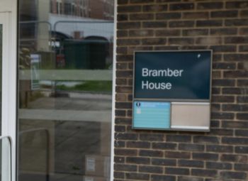 brick building with a blue sign reading 'Bramber House'