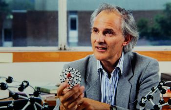 Sir Harry Kroto holding a model of buckminsterfullerene