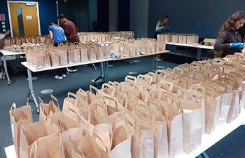 Recipe bags on tables waiting to be handed out to students