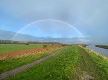 180 degree rainbow seen over a landscape and over the river Ouse in Sussex