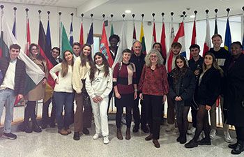 Students and staff at the European Parliament in Brussels stood in front of the European flags