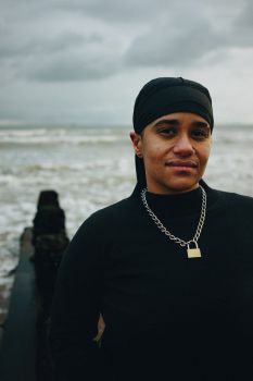 A photo of Subira Joy standing on a beach