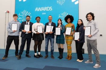 Photograph of all eight finalists of the Startup Sussex competition, 2024. Each are holding certificates.