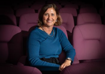A photograph of Ali Ramsey sitting in a cinema