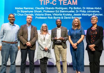 TIPC Team- Winners of Global Engagement. A few of the TIPC team members accepting an award on stage at the Sussex Awards.
