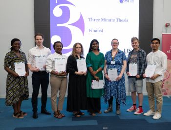 Three Minute Thesis (3MT) 2025 finalists standing together holding their certificates and smiling.