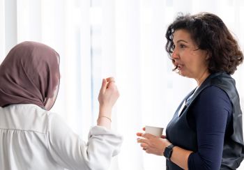 An image of two women talking