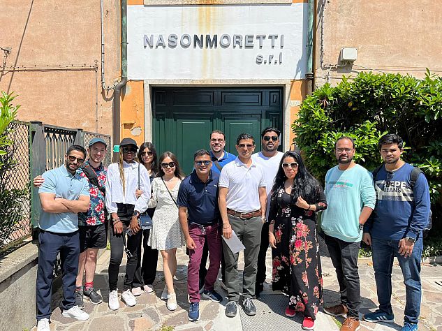 MBA students outside the door of the Nason Moretti glass factory with the Nason Moretti sign above teir heads