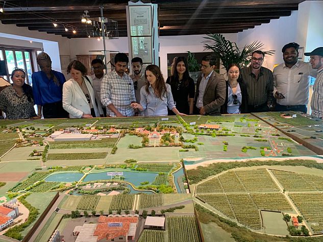 MBA students and staff at Villa Sandi prosecco makers vineyard. They are looking as a small scale model of their bio diverse land, hydroelectric power plant and the vineyards