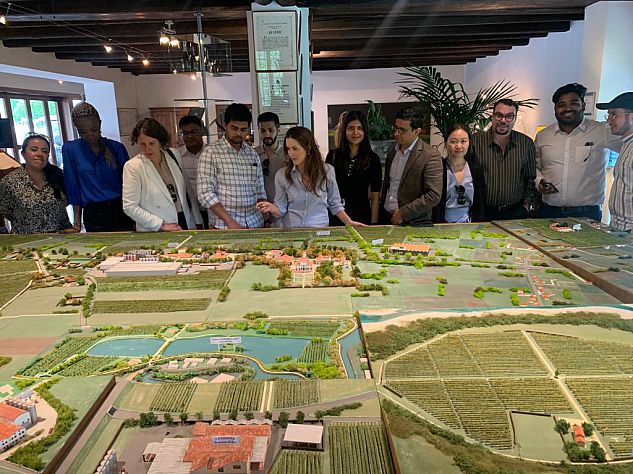 MBA students MBA students and staff at Villa Sandi prosecco makers vineyard. They are looking as a small scale model of their bio diverse land, hydroelectric power plant and the vineyards