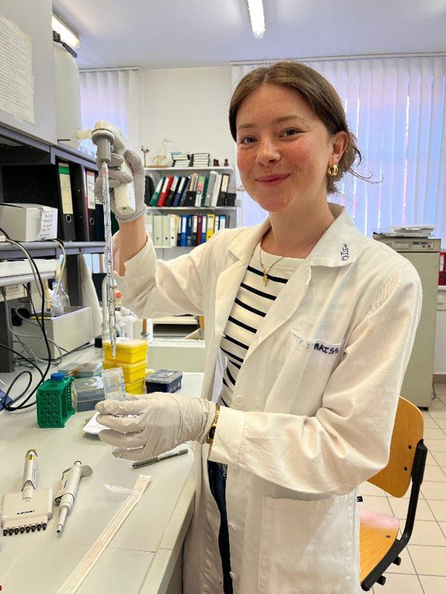 Maisy Vincent working in the lab, holding a pipette