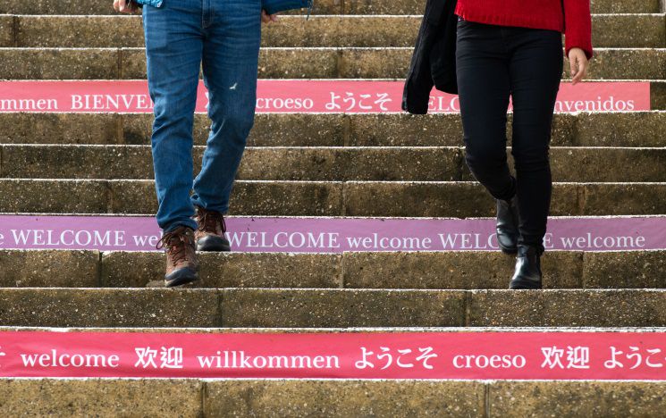 Icon: steps leading up outside campus, with 'hello' in various languages printed on the side of each
